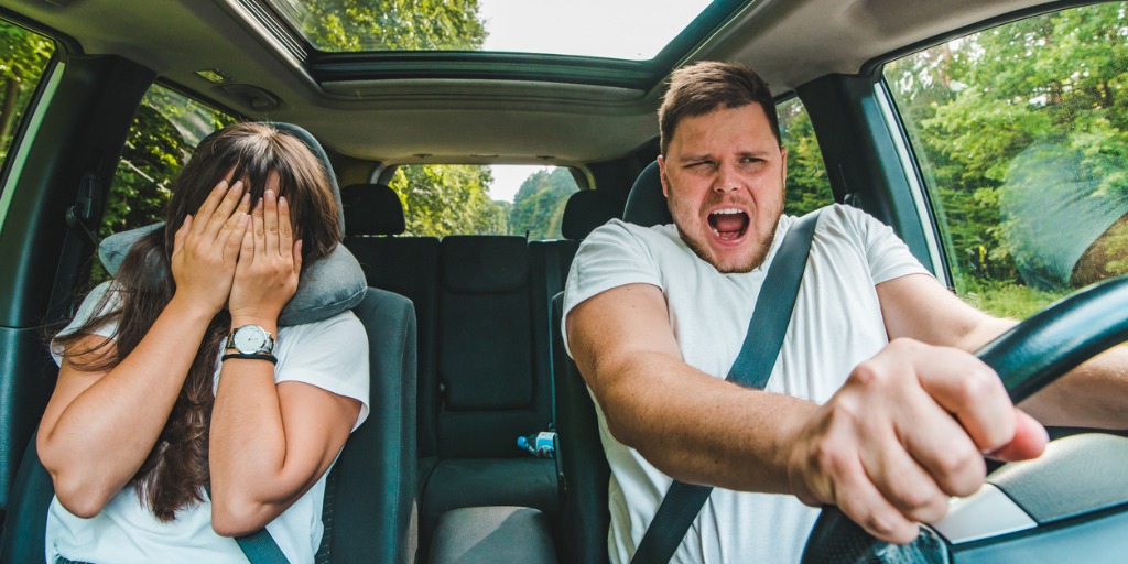 Couple inside a car reacting to almost getting into an 