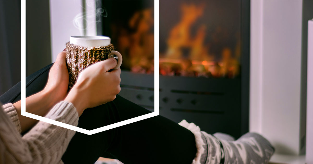 Woman Keeping Warm by a Winter Fireplace