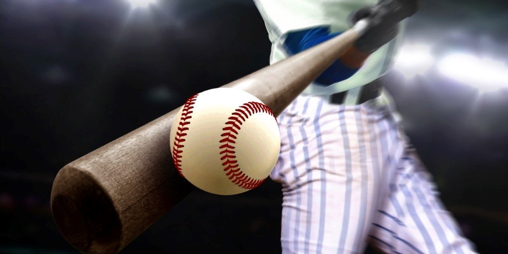 Baseball player swing hitting ball with bat in close up