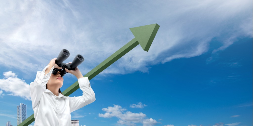 businesswoman with binoculars looking at increasing arr