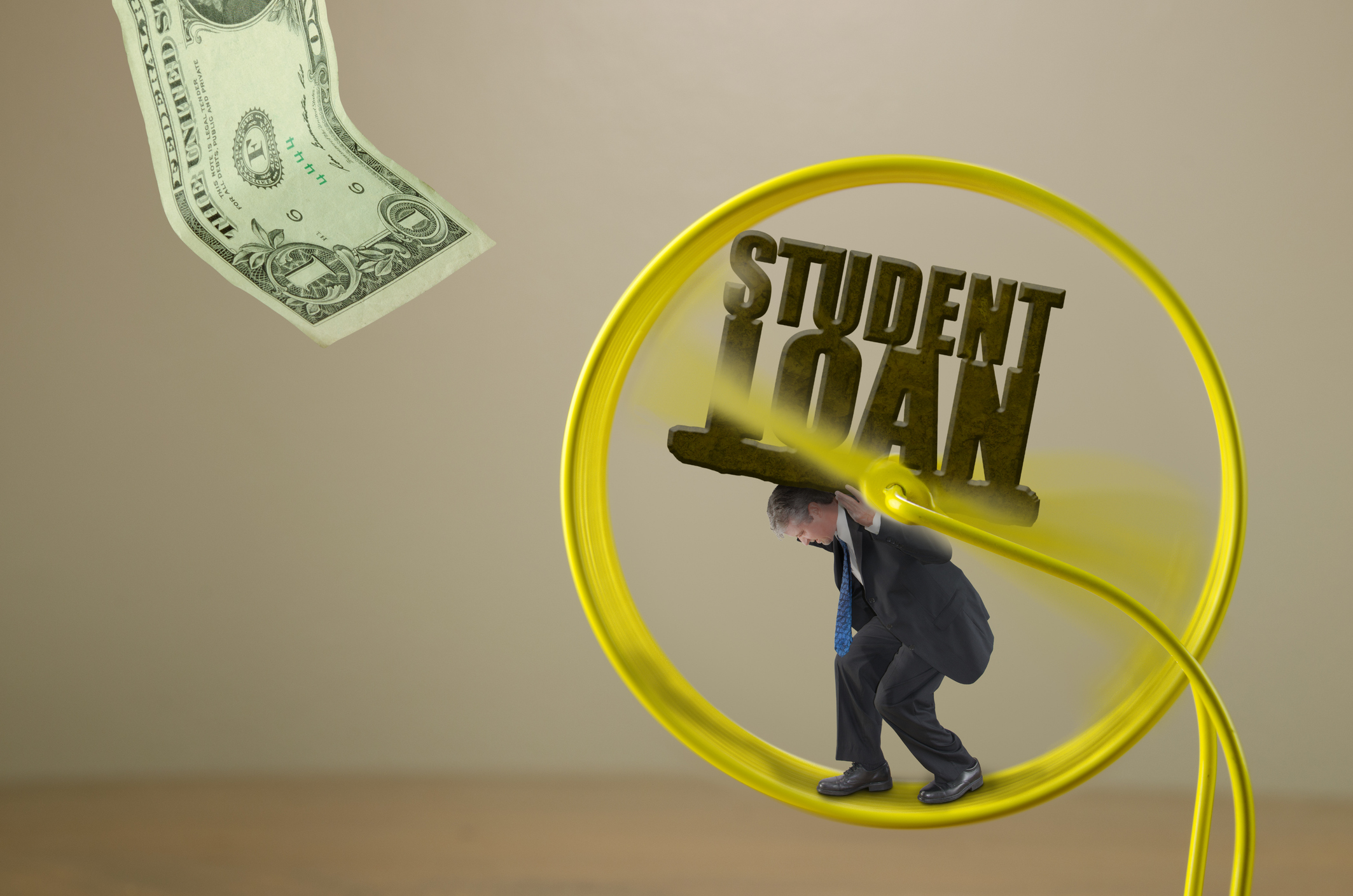 Man struggling to carry a huge STUDENT LOAN rock burden