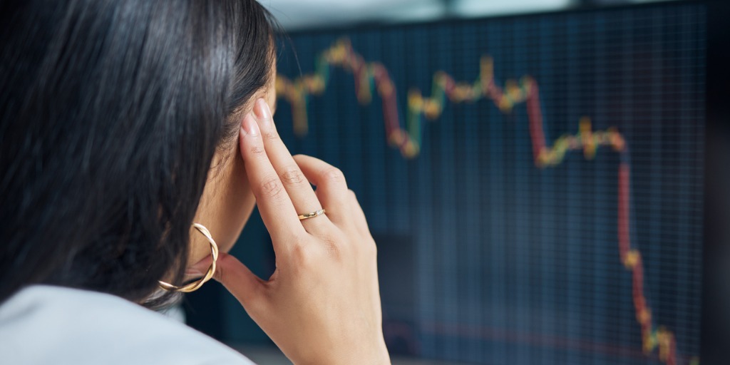 Woman looking at her computer seemingly stressed